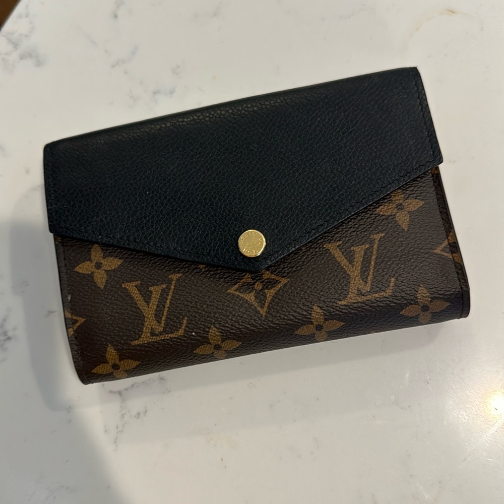 Authentic Louis Vuitton large wallet. Nearly perfect w/ one minor damage on back
